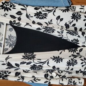 White and black layered cardigan with black sweater tee sewn in. Cathy Daniels